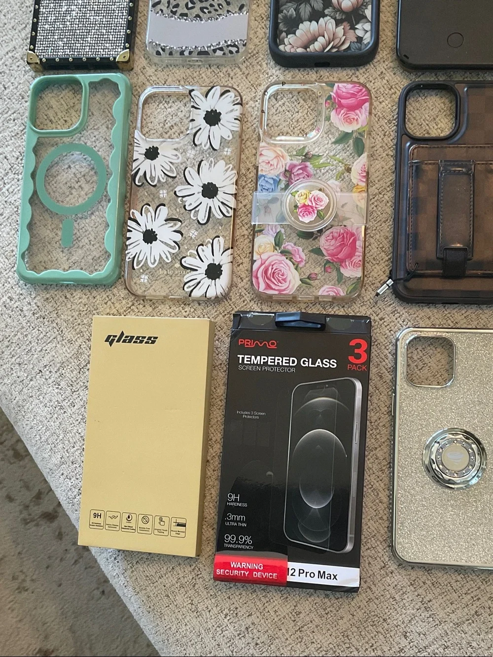 Assorted IPhone 12 Pro Max Phone cases and Screen Protectors